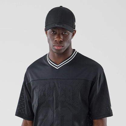 The model is wearing this New Era Mesh Oversized T-Shirt in black. 6