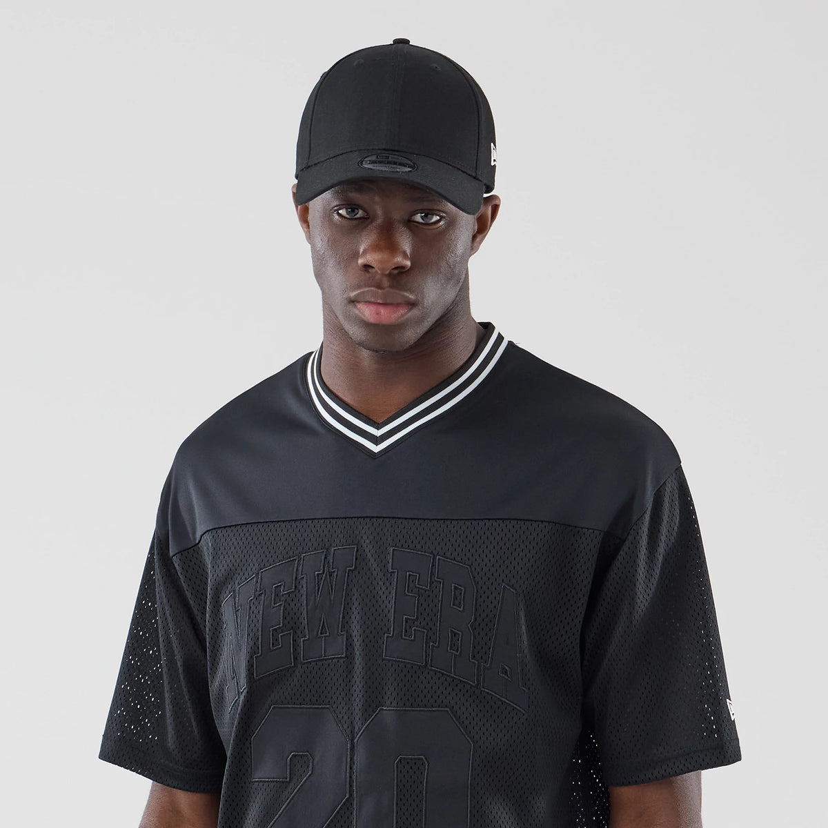 The model is wearing this New Era Mesh Oversized T-Shirt in black. 6