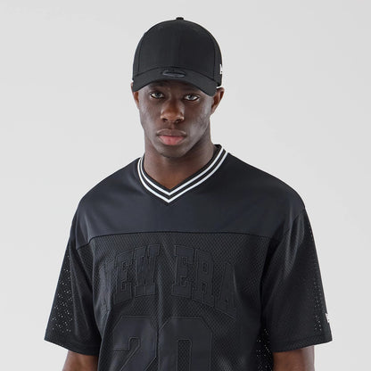 The model is wearing this New Era Mesh Oversized T-Shirt in black. 6