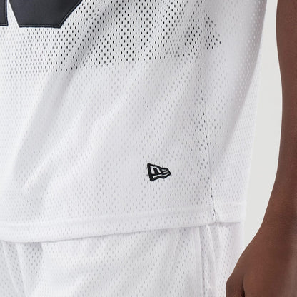 The model is wearing this New Era Mesh Oversized T-Shirt in white. 5