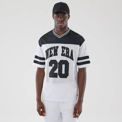 New Era Mesh White Oversized T-Shirt, front view on a model, featuring black 'NEW ERA' lettering across the chest, the number '20' printed below, and contrasting black stripes on the sleeves, styled with a simple black cap.