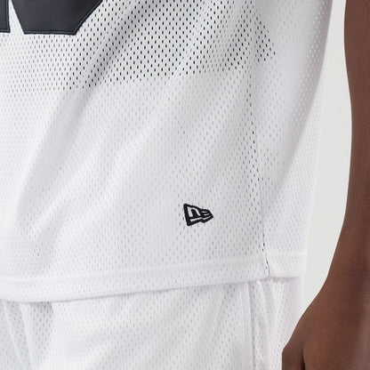 The model is wearing this New Era Mesh Oversized T-Shirt in white. 5