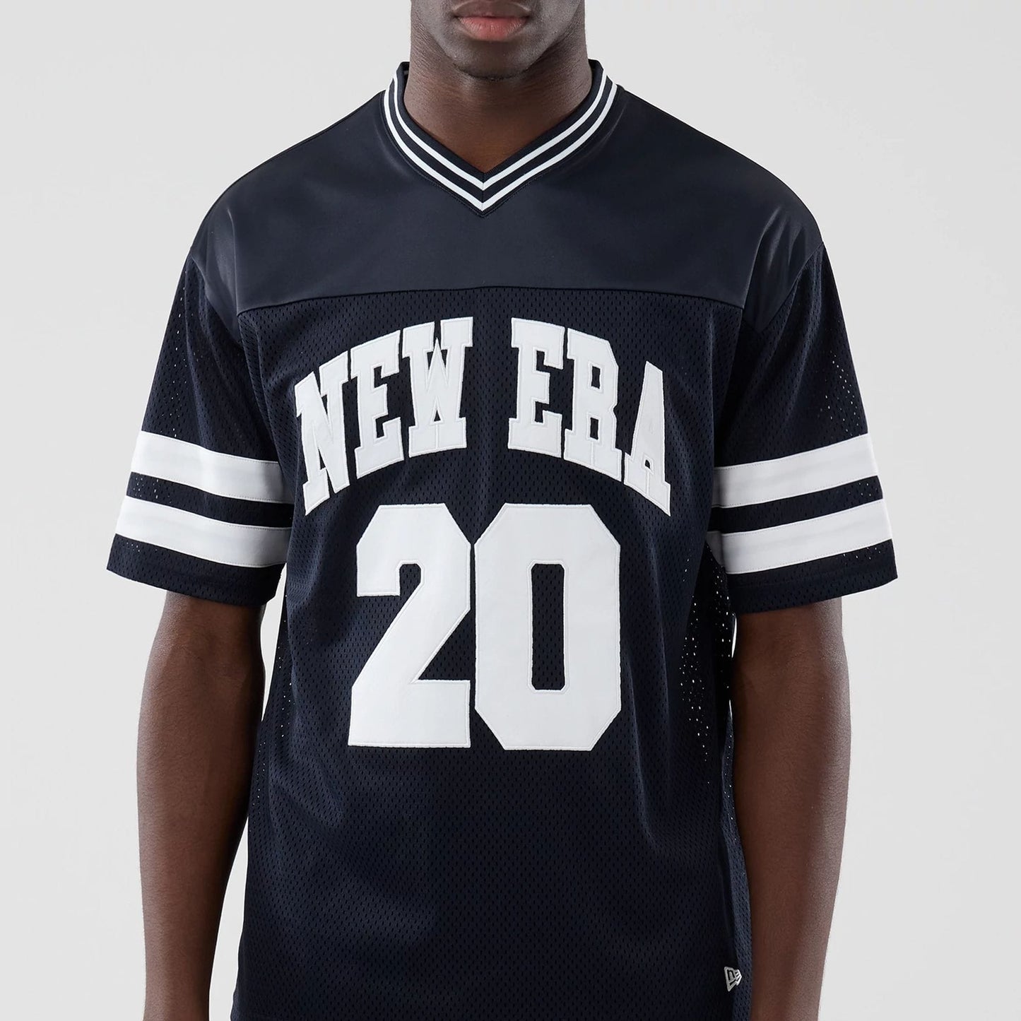The model is wearing this New Era Mesh Oversized T-Shirt in navy. 3