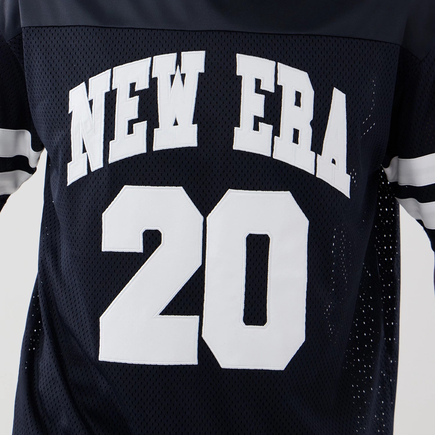 The model is wearing this New Era Mesh Oversized T-Shirt in navy. 4