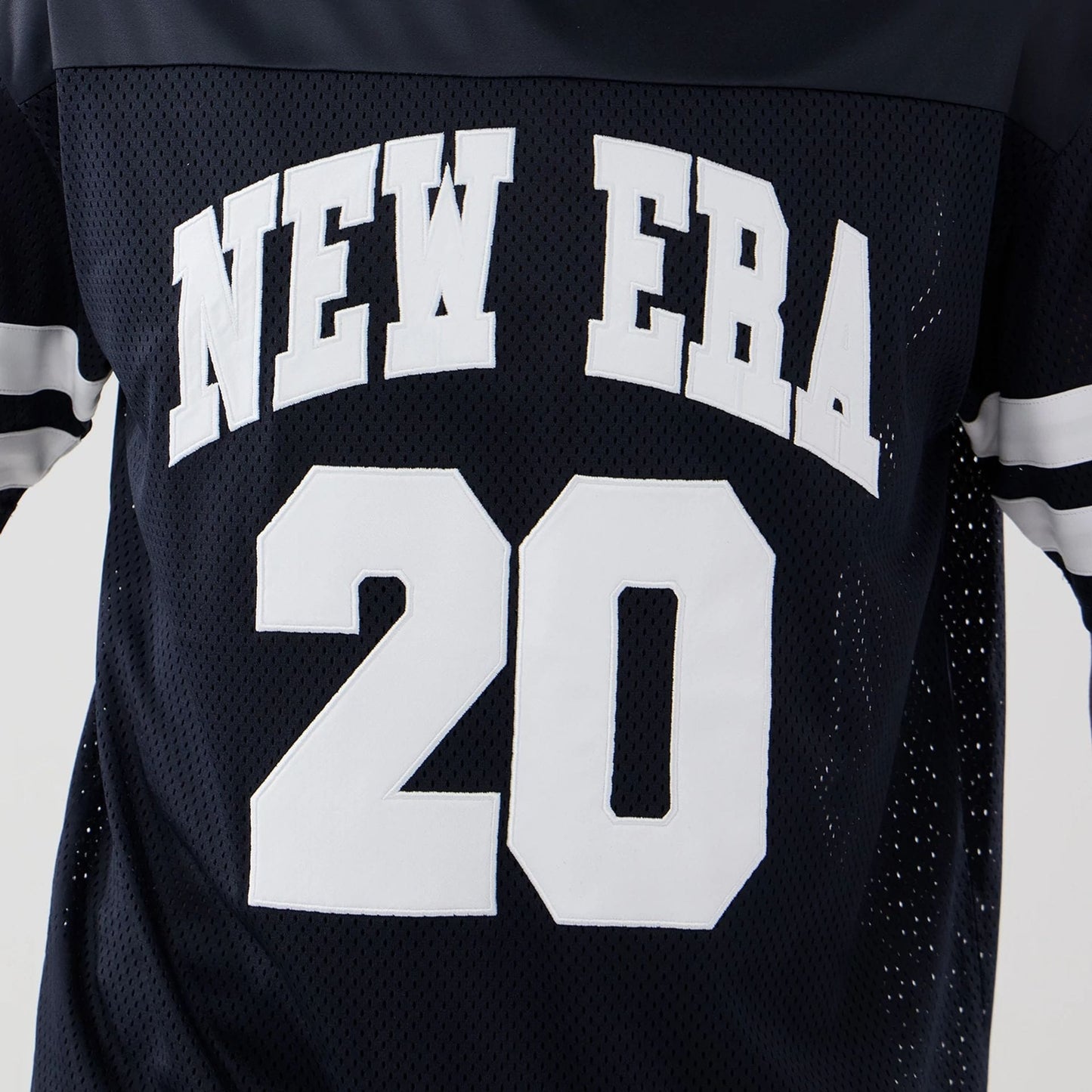 The model is wearing this New Era Mesh Oversized T-Shirt in navy. 4