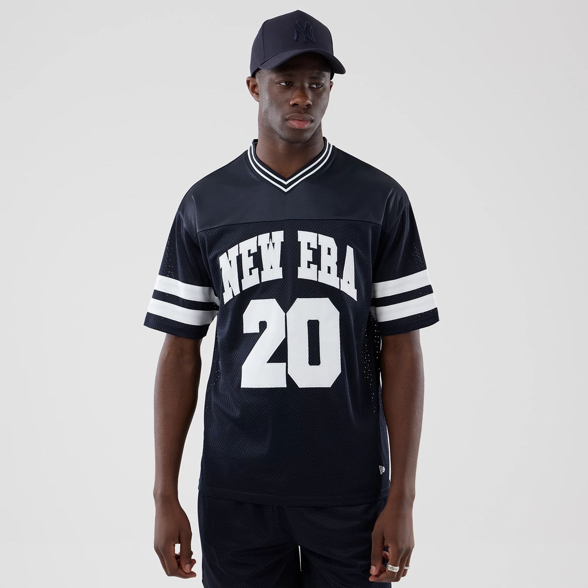 The model is wearing this New Era Mesh Oversized T-Shirt in navy. 1