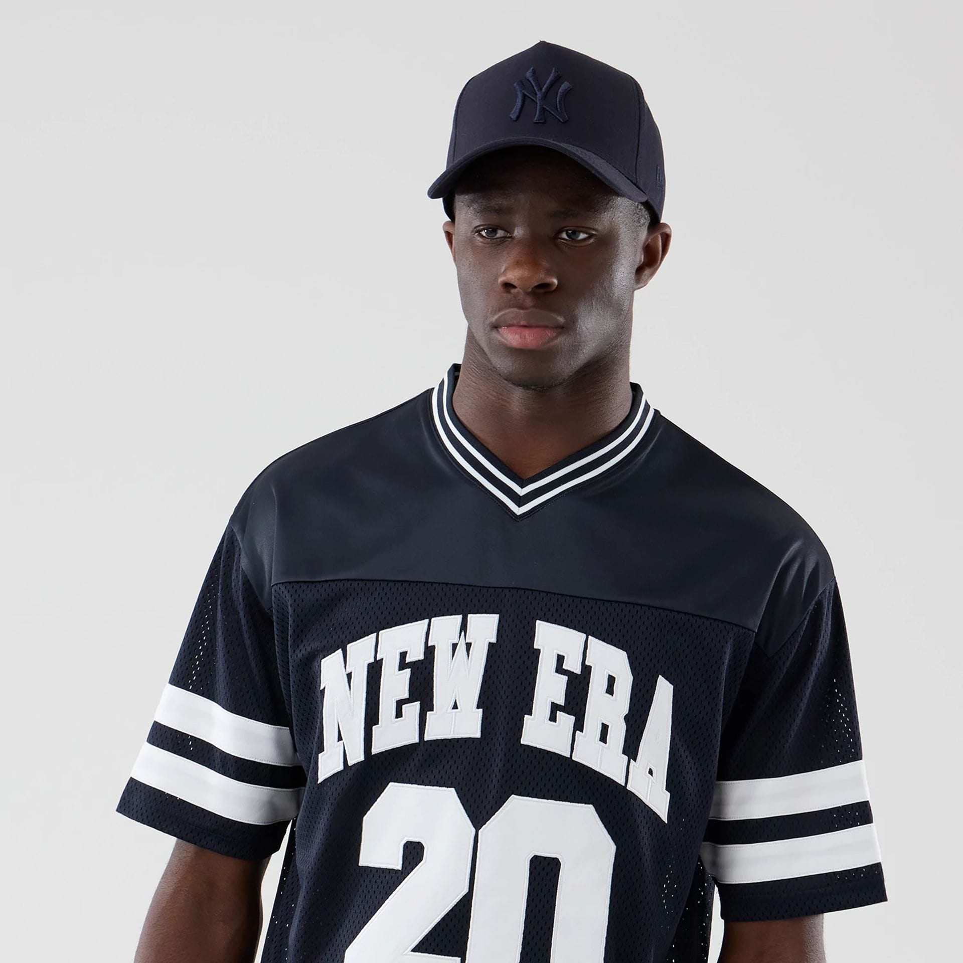 The model is wearing this New Era Mesh Oversized T-Shirt in navy. 6