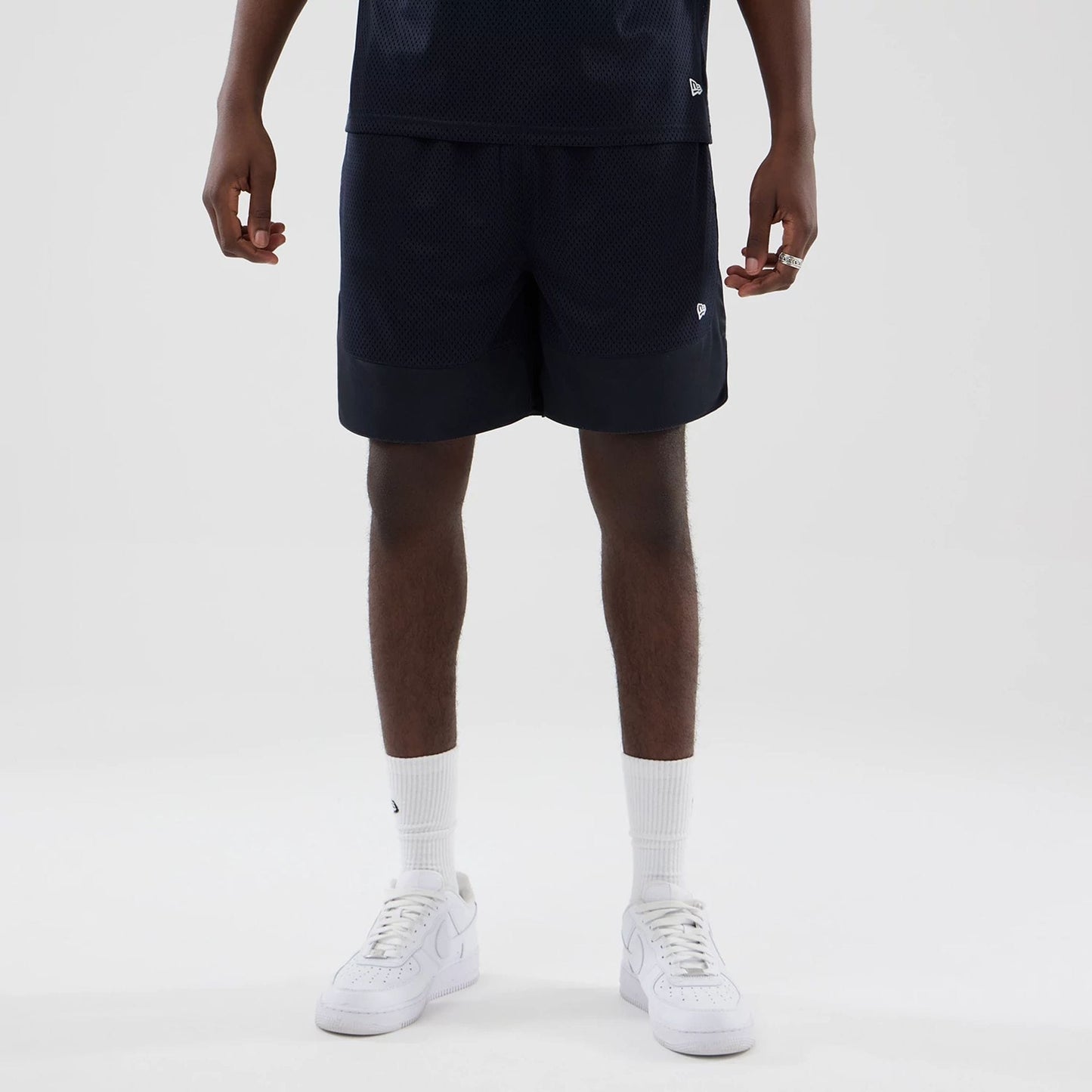 The model is wearing this New Era Mesh Oversized Shorts in navy. 5