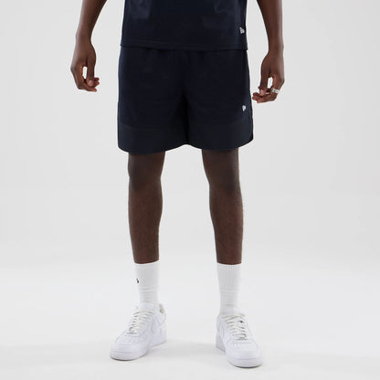 The model is wearing this New Era Mesh Oversized Shorts in navy. 5
