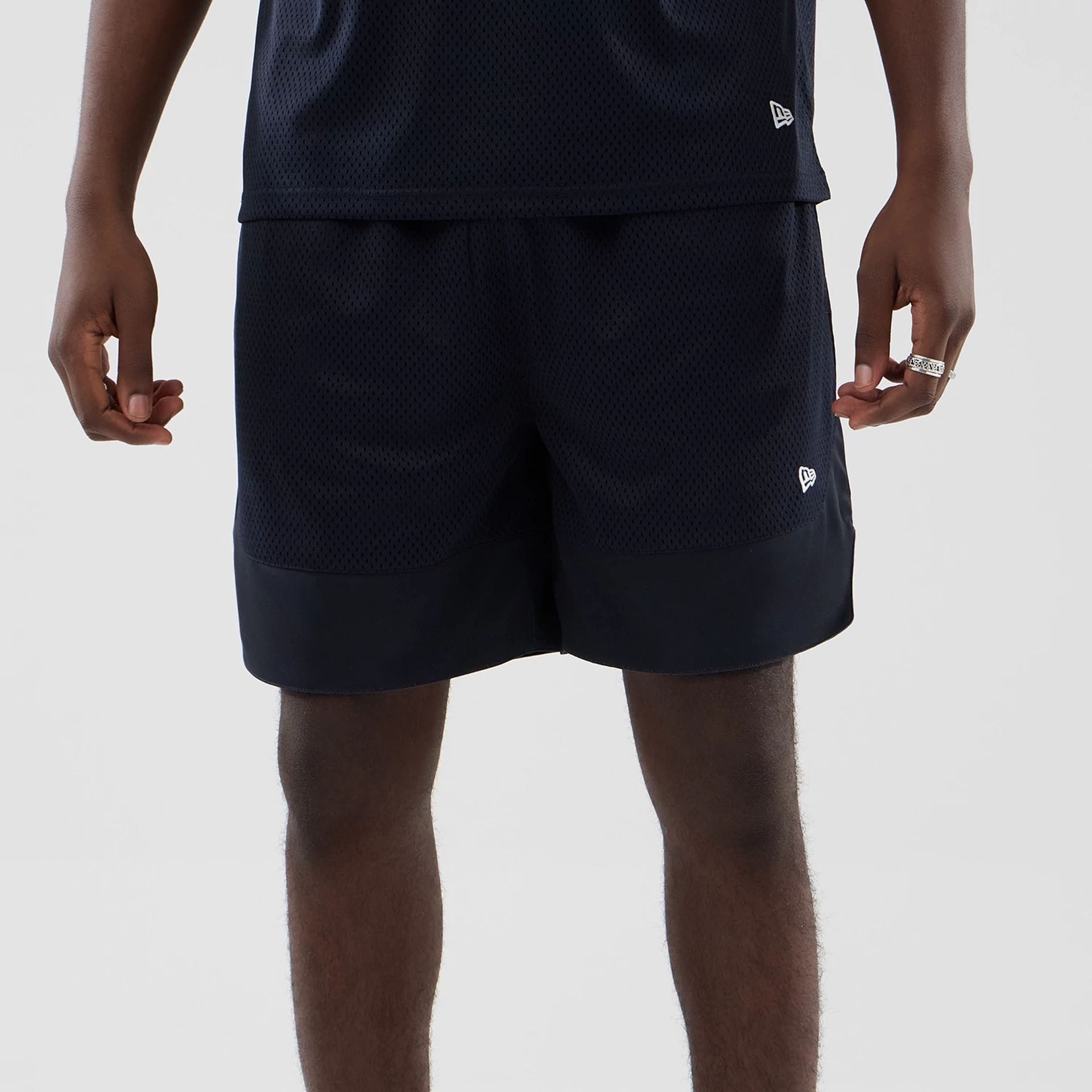 The model is wearing this New Era Mesh Oversized Shorts in navy. 6