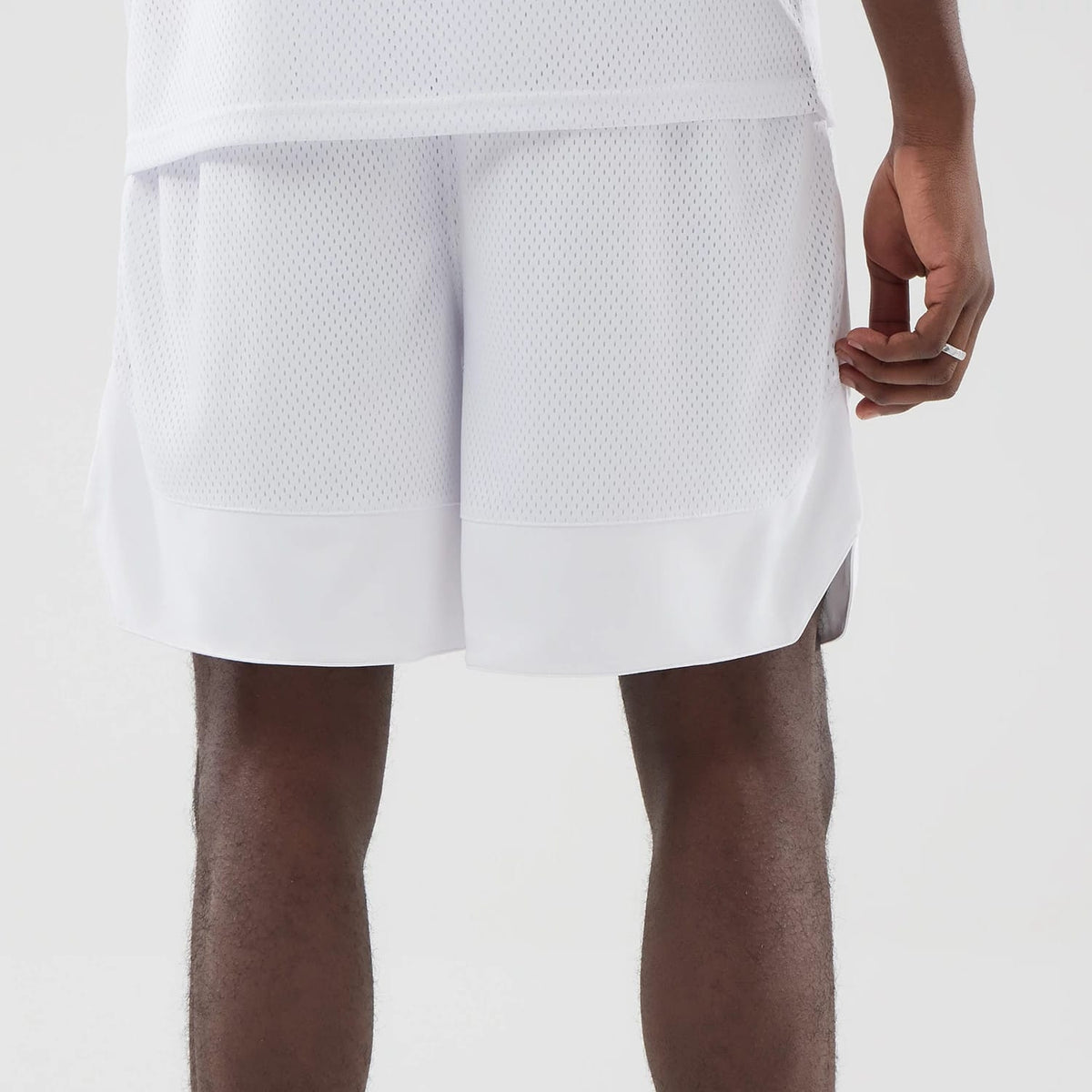The model is wearing this New Era Mesh Oversized Shorts in white. 6