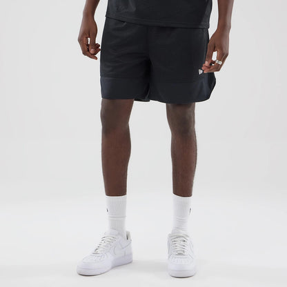 The model is wearing this New Era Mesh Stripe Oversized Shorts in black. 3