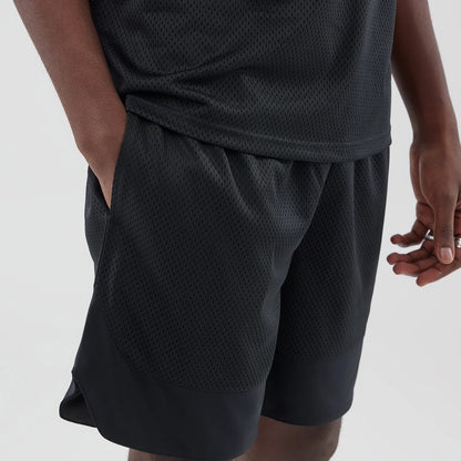 The model is wearing this New Era Mesh Oversized Shorts in black. 4
