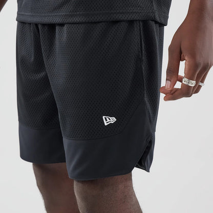The model is wearing this New Era Mesh Stripe Oversized Shorts in black. 5