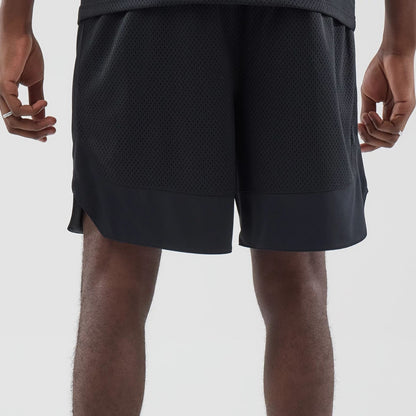 The model is wearing this New Era Mesh Oversized Shorts in black. 7