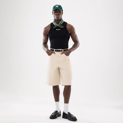 The model is wearing this New Era Rib Vest in black. 12