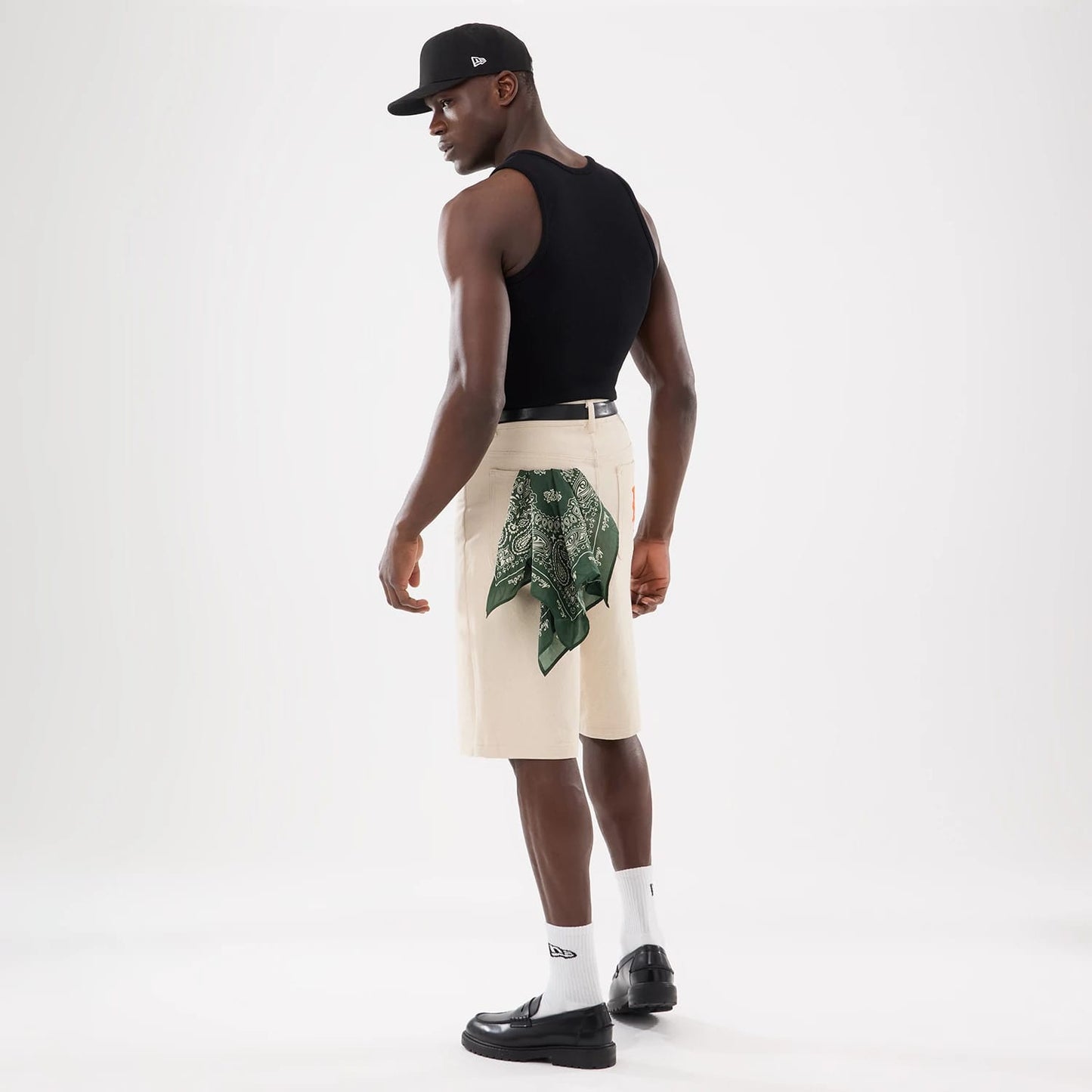 The model is wearing this New Era Rib Vest in black. 12