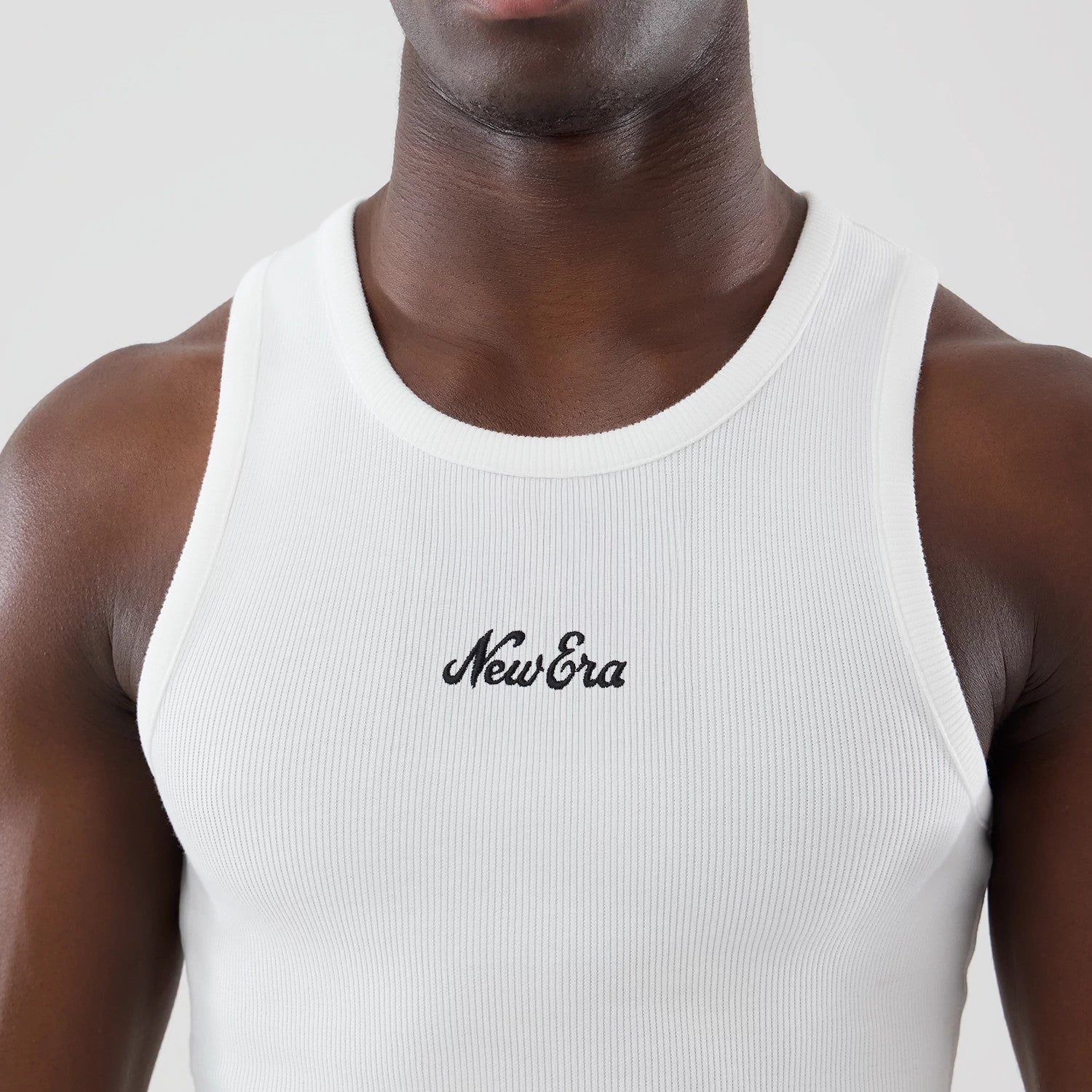 The model is wearing this New Era Rib Vest in white. 4