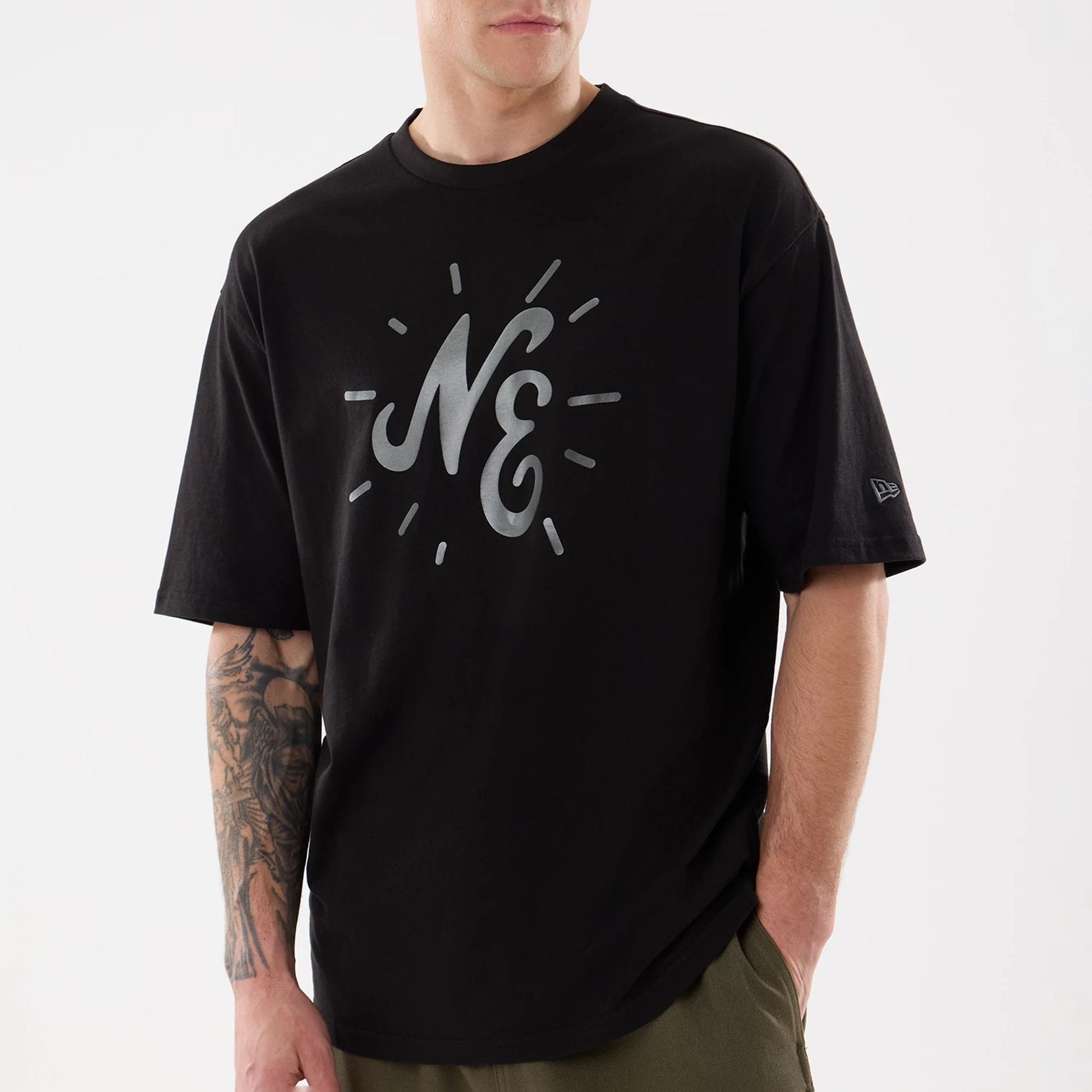 The model is wearing this New Era 59FIFTY Day Graphic T-Shirt in black. 3