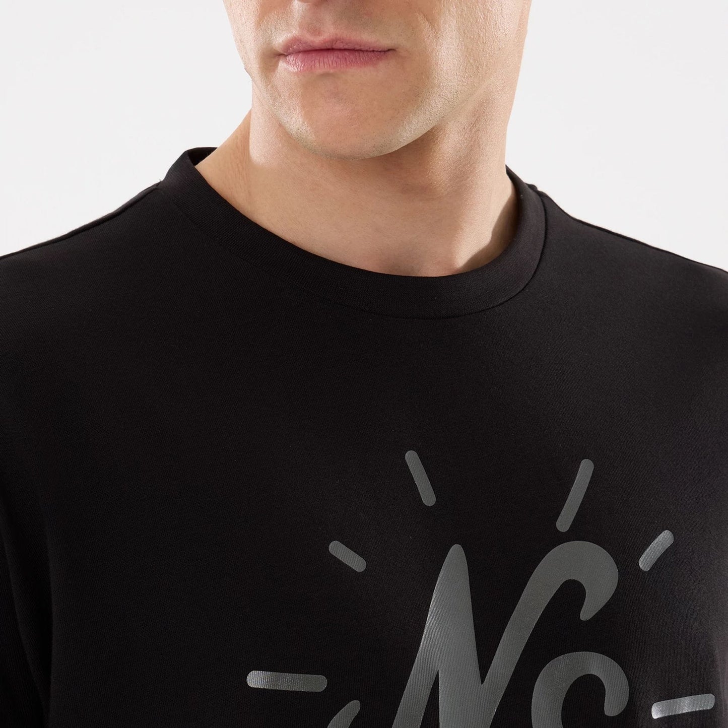 The model is wearing this New Era 59FIFTY Day Graphic T-Shirt in black. 4