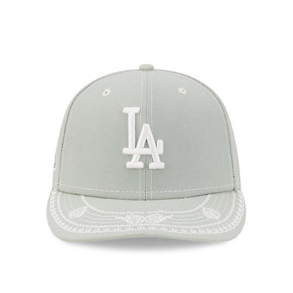 LA Dodgers MLB Pastel Green New Era 59FIFTY Fitted Cap, front view showing a white embroidered LA logo on the crown, intricate white decorative stitching on the pastel green visor, and white eyelets on each panel.