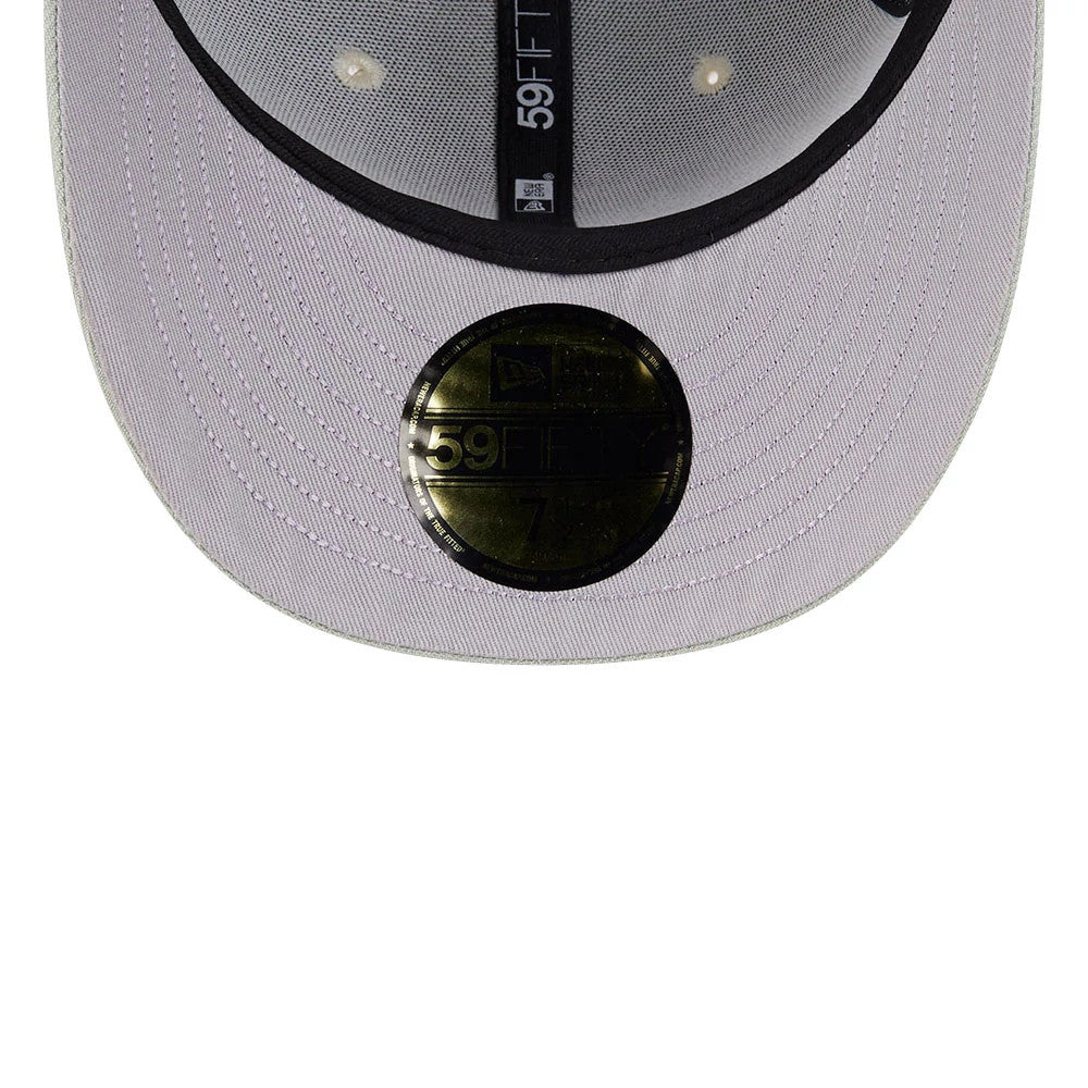 LA Dodgers MLB Pastel Green New Era 59FIFTY Fitted Cap, inside view showing the black printed taping with 59FIFTY branding, a gold 59FIFTY size sticker on the lavender undervisor, and the black sweatband lining the interior.