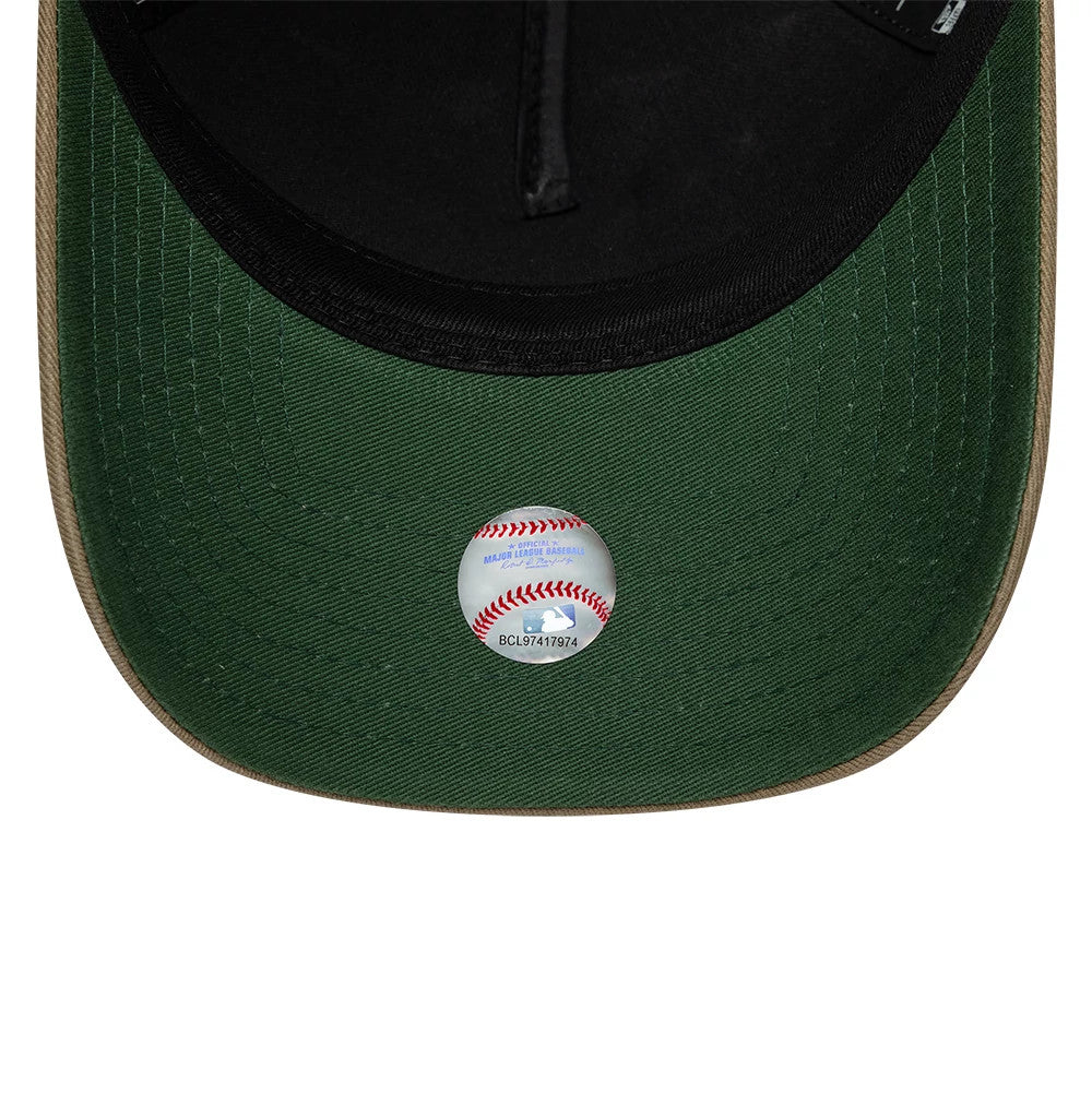 LA Dodgers MLB Vibrant Festivities Beige New Era 9FORTY A-Frame Adjustable Cap, inside view showing a green undervisor with a black sweatband, and a round MLB holographic sticker featuring a baseball design at the centre.