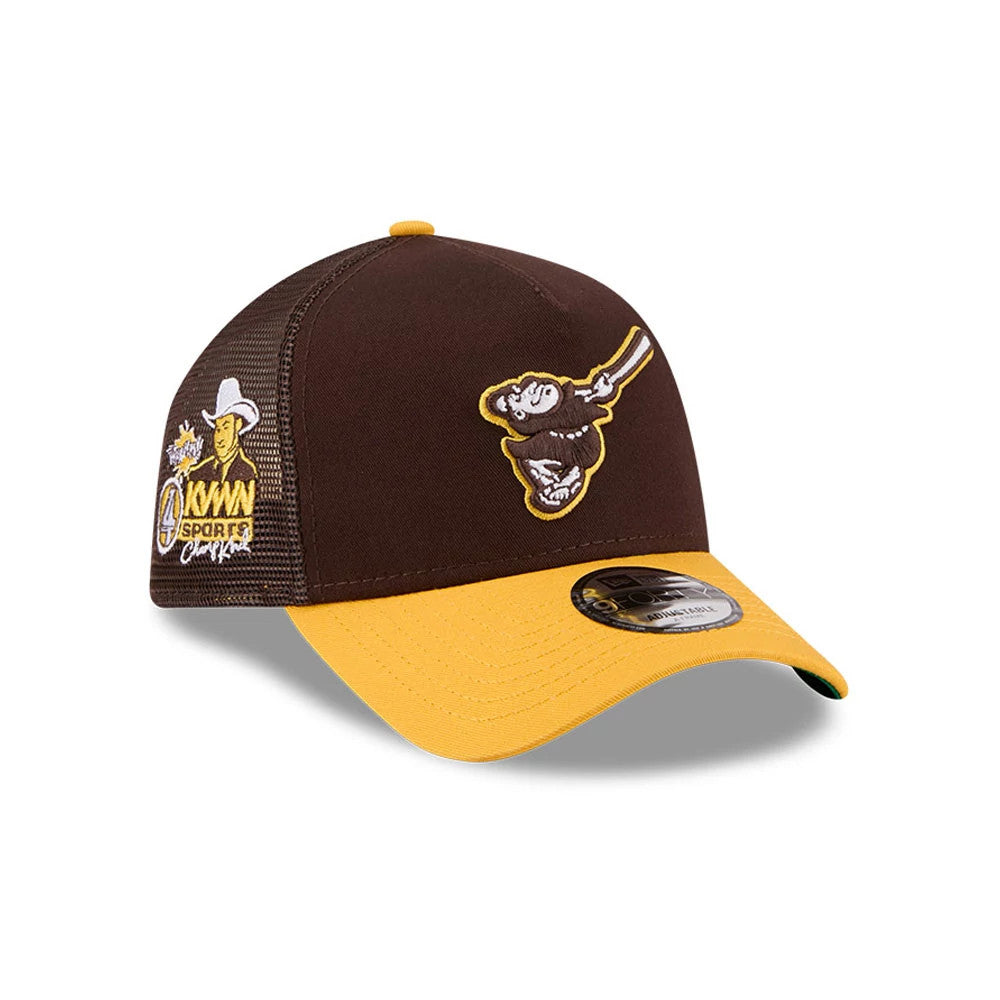 Padres MLB X Anchorman Whammy Dark Brown New Era 9FORTY A-Frame Trucker Adjustable Cap, three-quarter view showing the embroidered swinging friar logo on the front panel with a contrasting yellow visor and a 9FORTY size sticker.