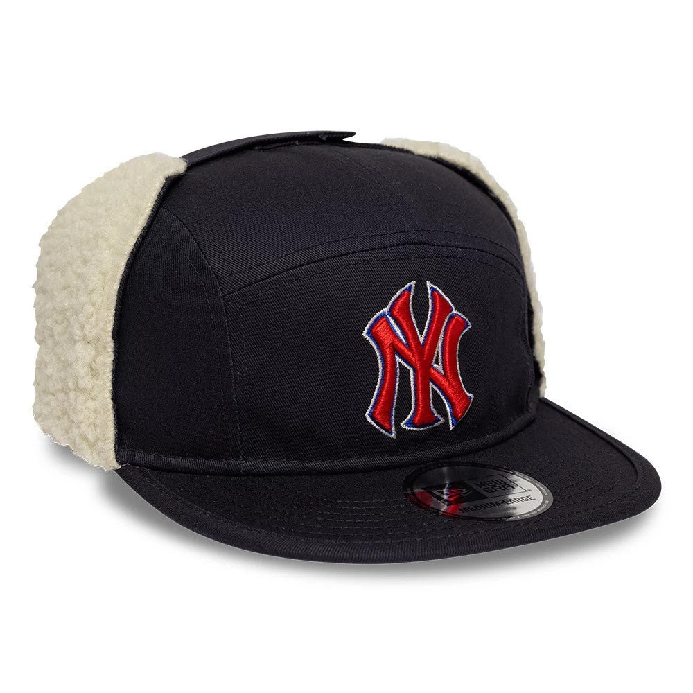 New Era New York Yankees MLB Navy Dogear Camper Adjustable Cap, three-quarter view showing the red raised NY logo on the front panel, cream dog-ear flaps on the side, and the New Era 9FORTY size sticker on the curved navy visor.