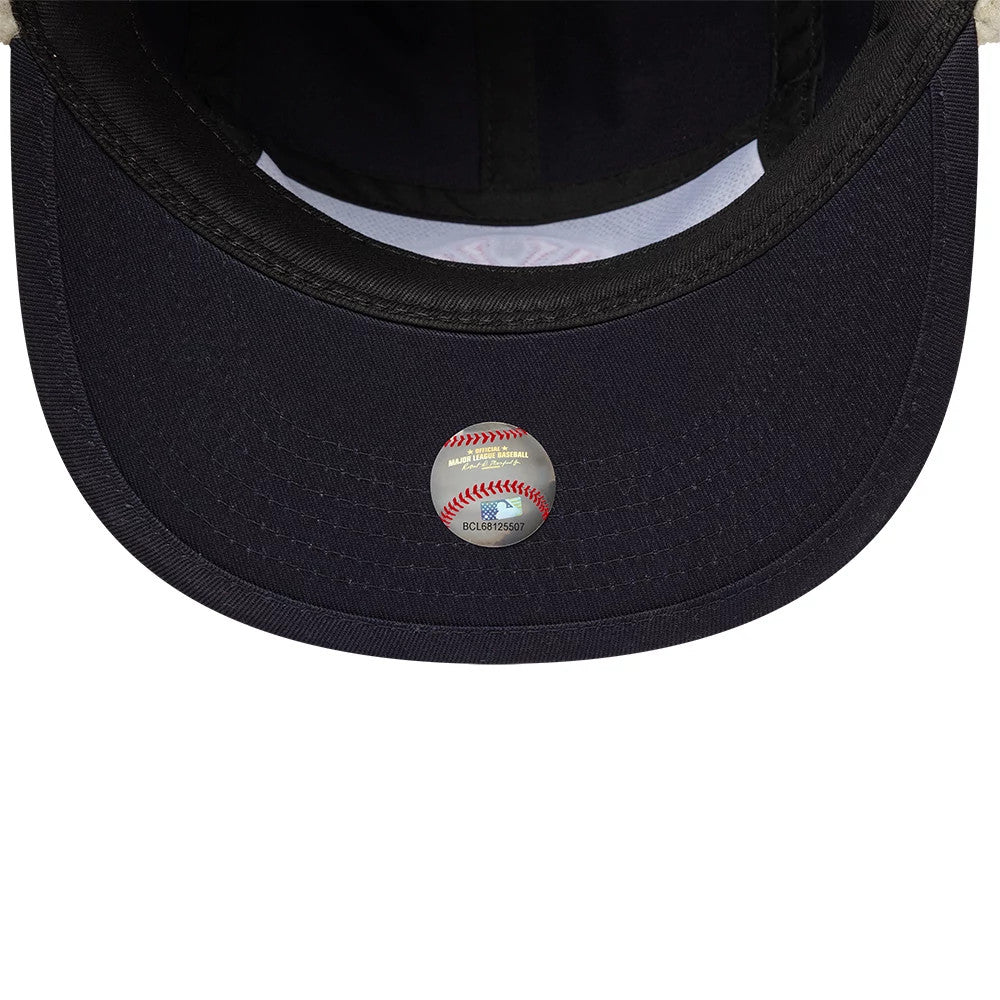 New Era New York Yankees MLB Navy Dogear Camper Adjustable Cap, inside view showing the black undervisor with fine stitching, a white sweatband lining, and a silver baseball-themed MLB sticker placed centrally on the underside.