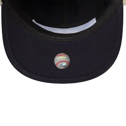 New Era New York Yankees MLB Navy Dogear Camper Adjustable Cap, inside view showing the black undervisor with fine stitching, a white sweatband lining, and a silver baseball-themed MLB sticker placed centrally on the underside.