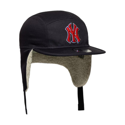 New Era New York Yankees MLB Navy Dogear Camper Adjustable Cap, three-quarter view showing the red embroidered NY logo on the front panel, a black flat visor with an adjustable strap at the back, and the cosy fleece-lined ear flaps.