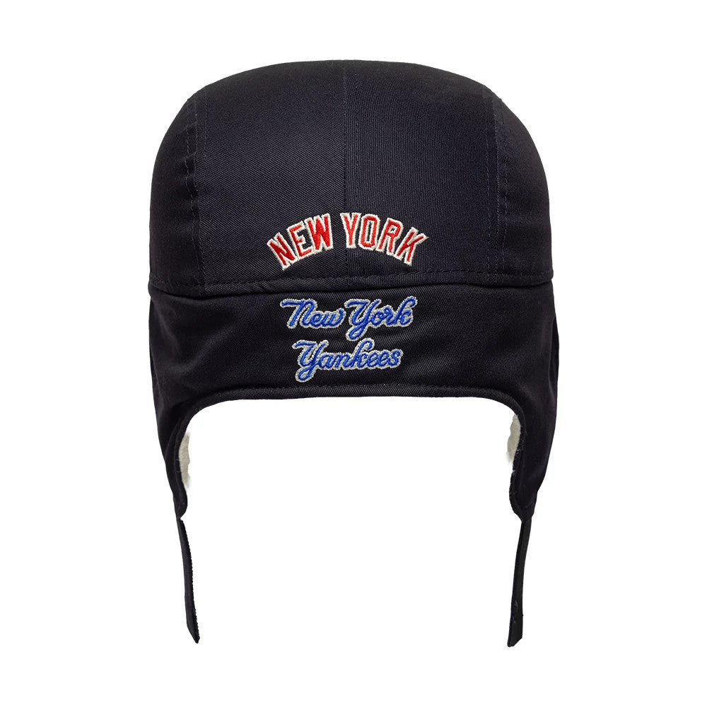 New Era New York Yankees MLB Navy Dogear Camper Adjustable Cap, front view showing red New York lettering embroidered above blue New York Yankees script on the structured navy crown, with earflaps featuring a soft lining for added warmth.
