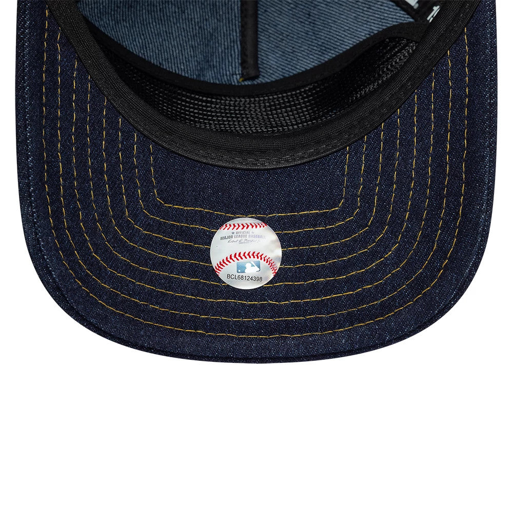 New York Yankees MLB Denim Navy New Era 19TWENTY Adjustable Cap, inside view showing a navy undervisor with contrasting yellow stitching, a black sweatband at the edge, and a baseball-themed sticker at the centre of the visor.
