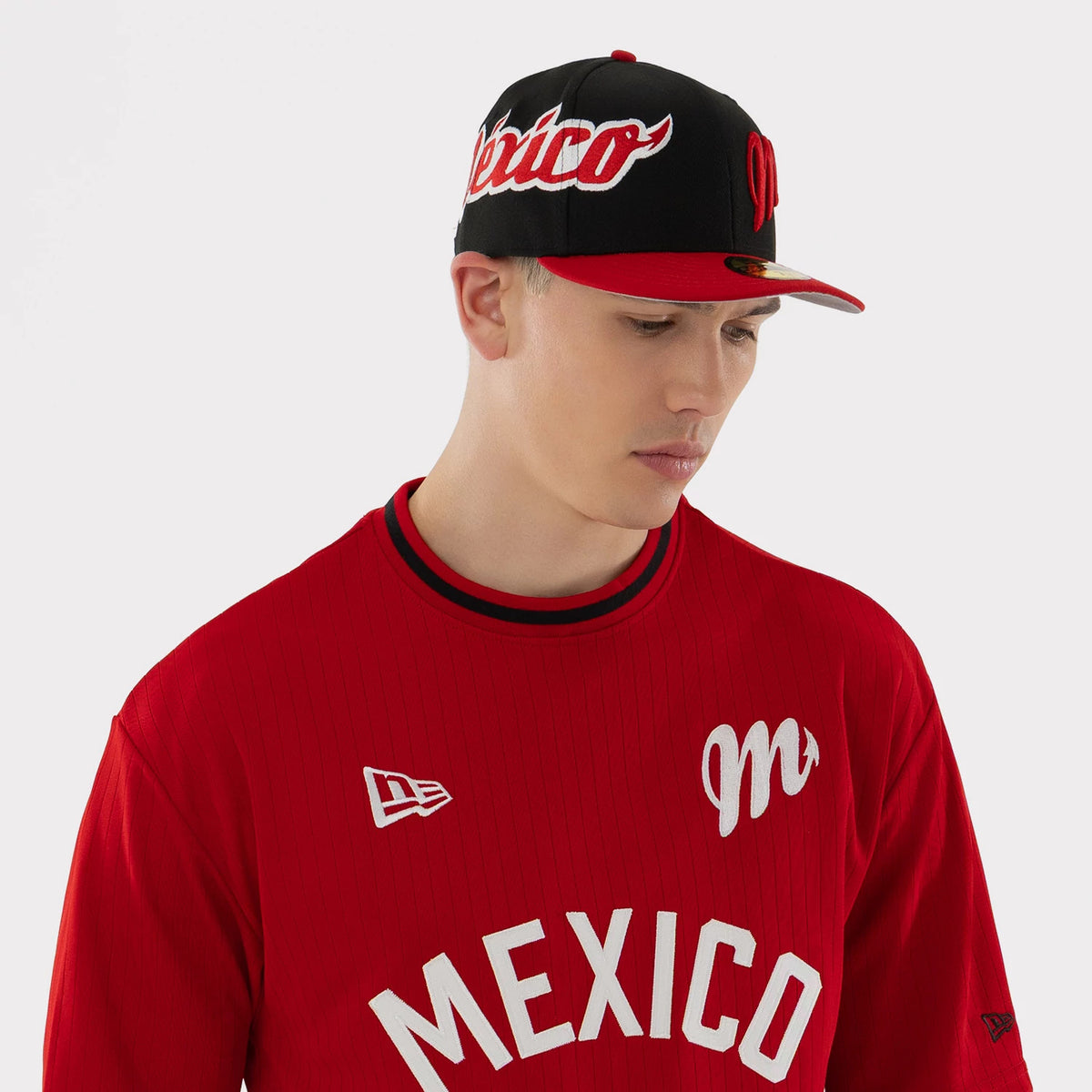 The model is wearing this LMB Mexico Diablos Oversized T-Shirt in red. 3