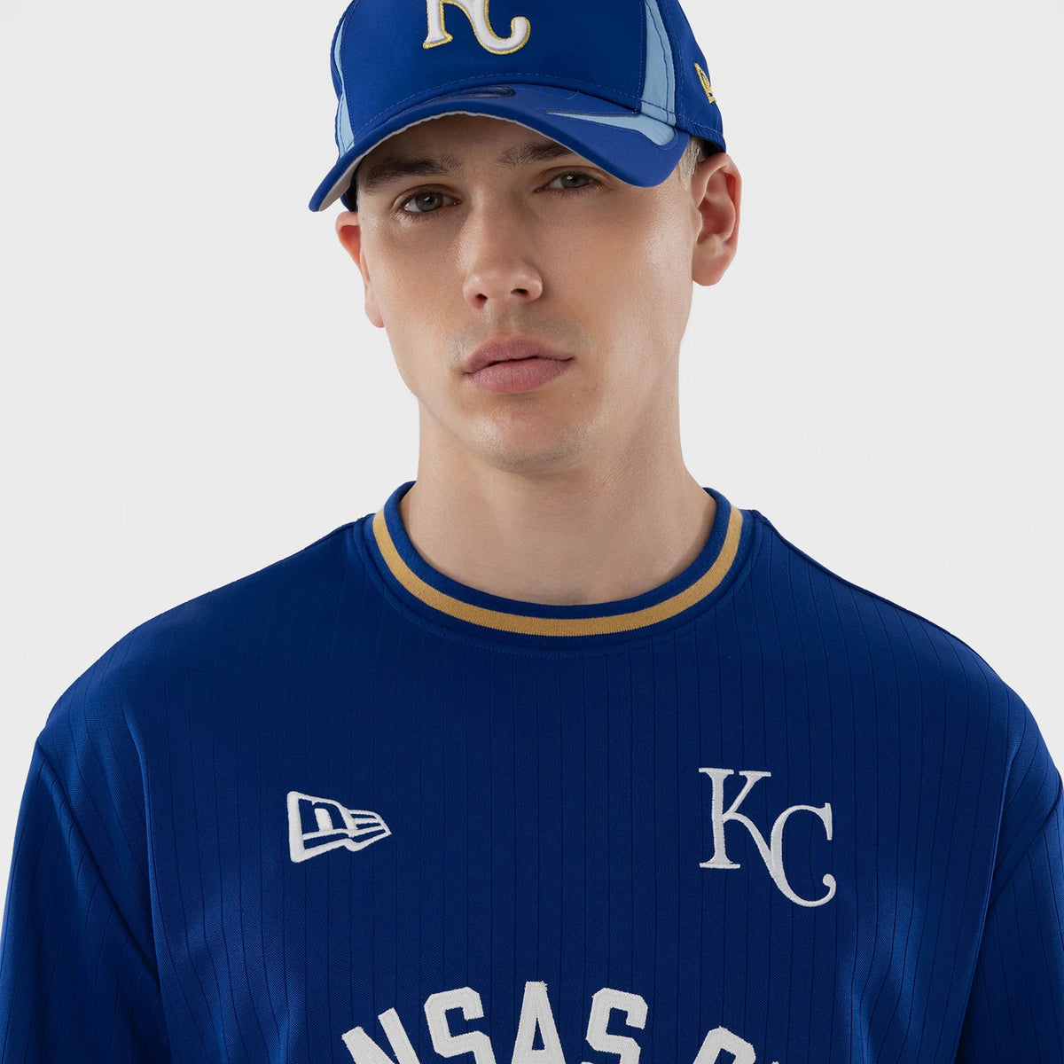 New Era Kansas City Royals MLB Blue Oversized T-Shirt, front view on-model featuring large white embroidered KC letters on the chest, a white embroidered New Era logo on the left, and KANSAS CITY lettering across the upper front.