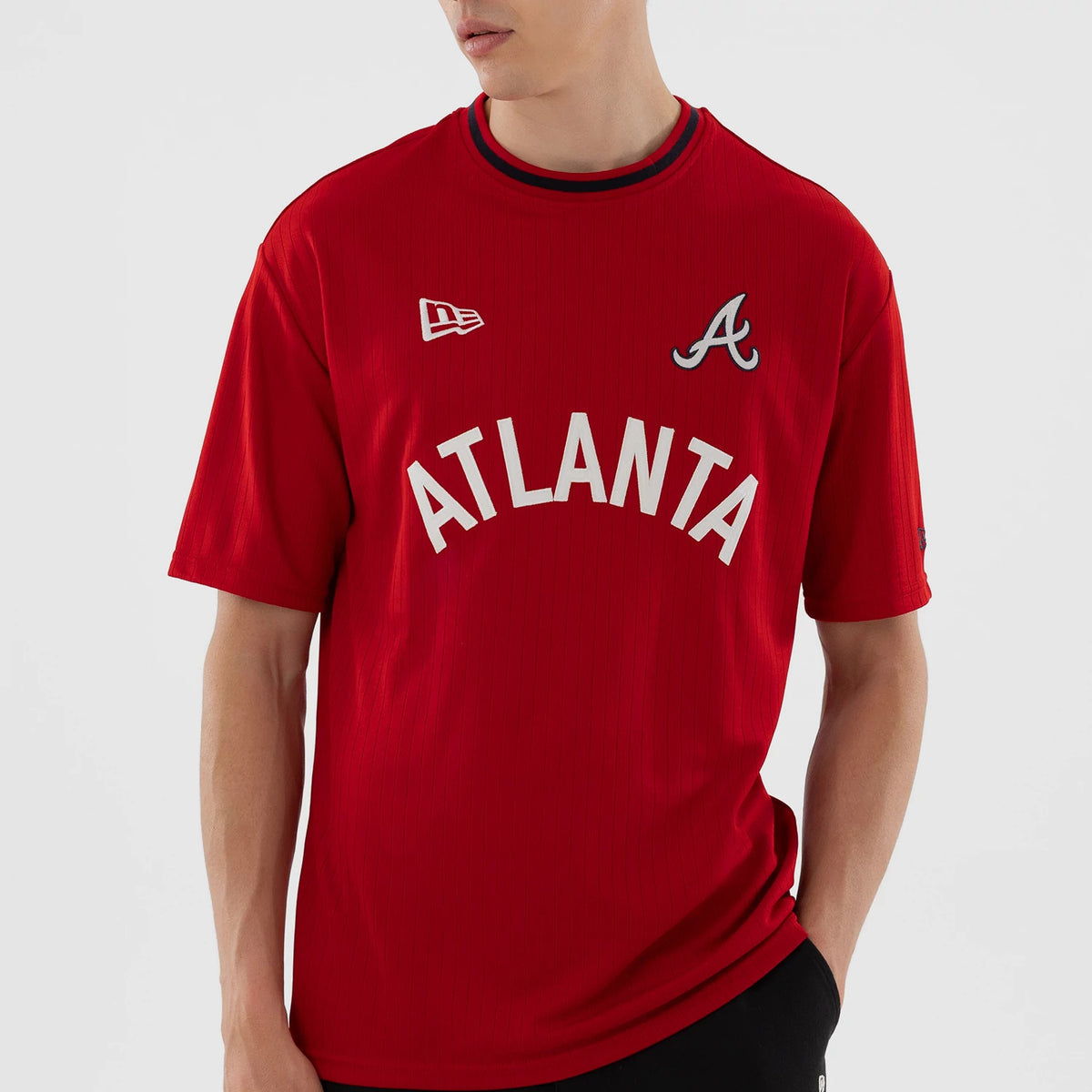 New Era Atlanta Braves MLB Red Oversized T-Shirt, front view on a model showing the white ATLANTA text across the chest, an embroidered New Era logo on the right shoulder, and the Braves A logo on the left.