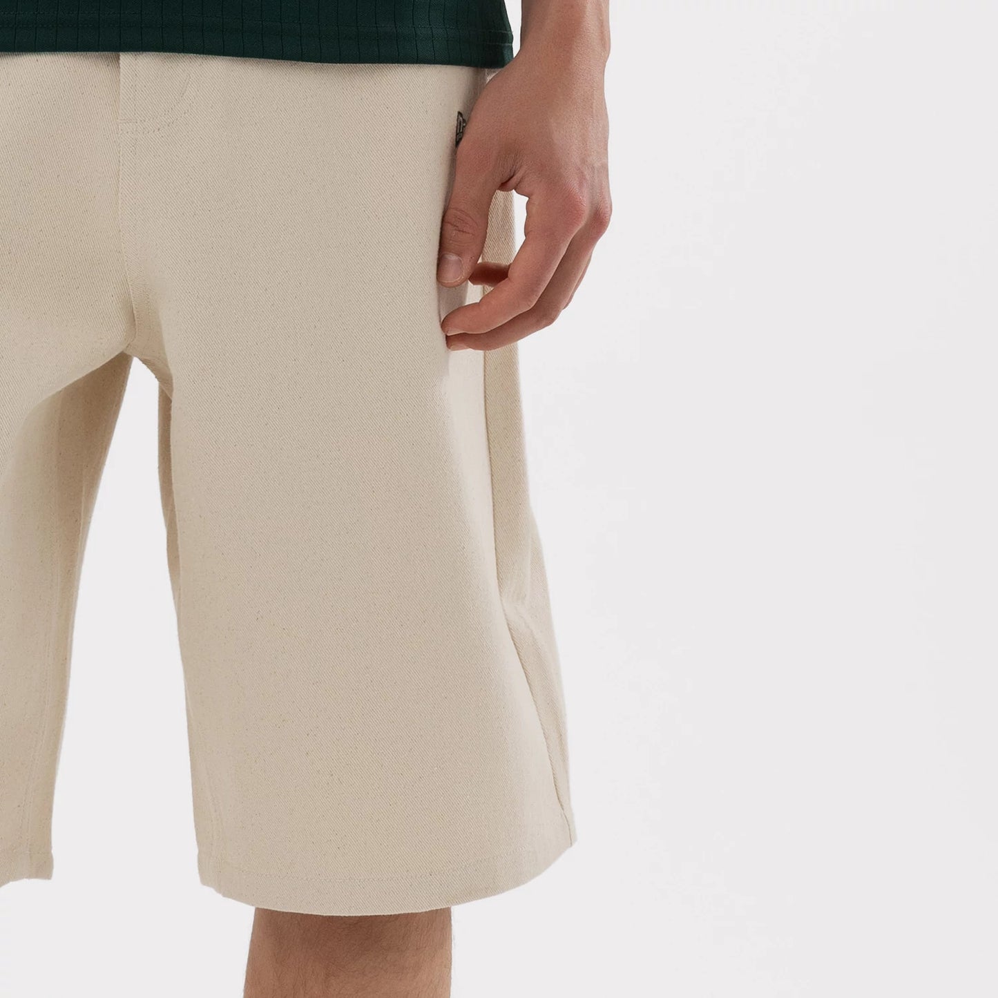 The model is wearing this MLB Jort Athletics Oversized Shorts in Cream. 5