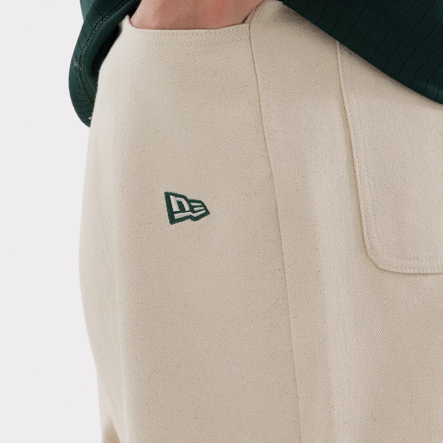 The model is wearing this MLB Jort Athletics Oversized Shorts in Cream. 4