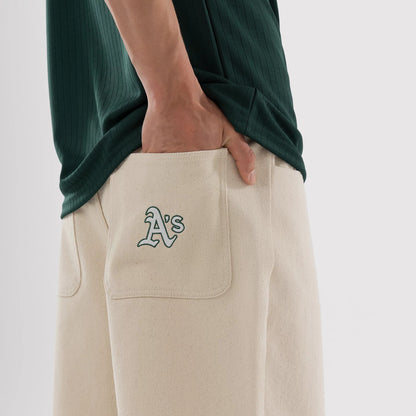 The model is wearing this MLB Jort Athletics Oversized Shorts in Cream. 3