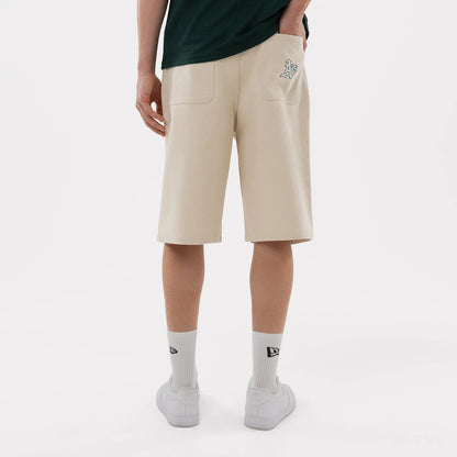 The model is wearing this MLB Jort Athletics Oversized Shorts in Cream. 2