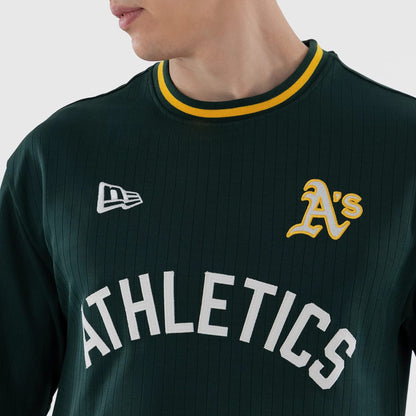 The model is wearing this MLB Athletics Oversized T-Shirt in dark green. 4