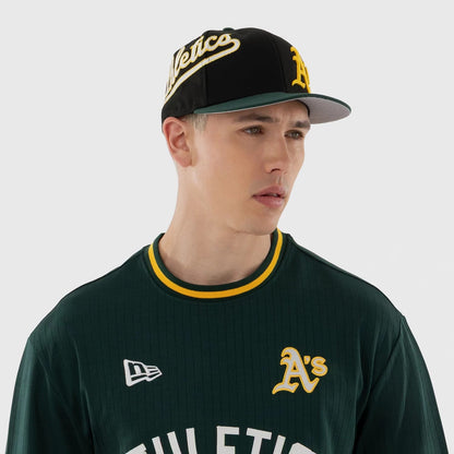 The model is wearing this MLB Athletics Oversized T-Shirt in dark green. 3