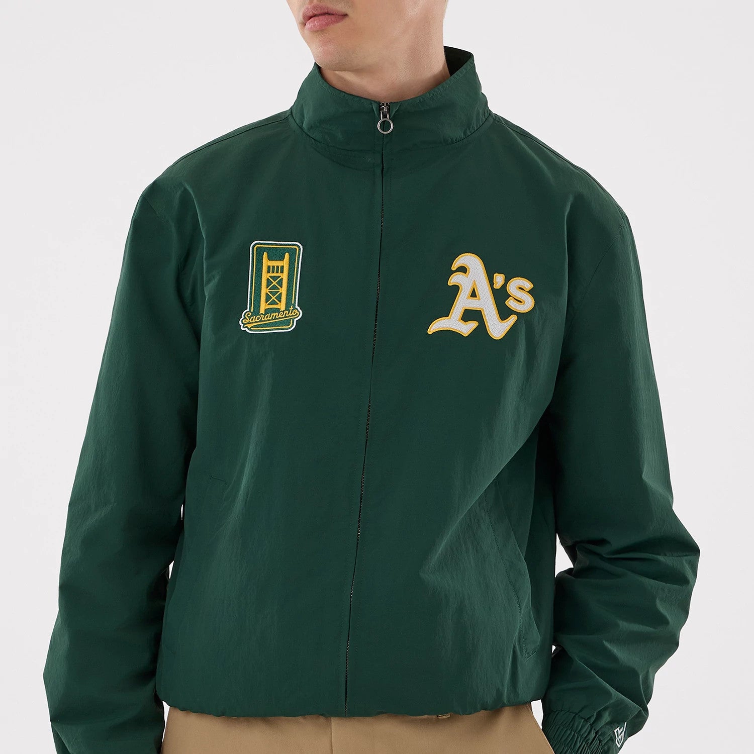 The model is wearing this MLB Athletics Sports Jacket in dark green. 3