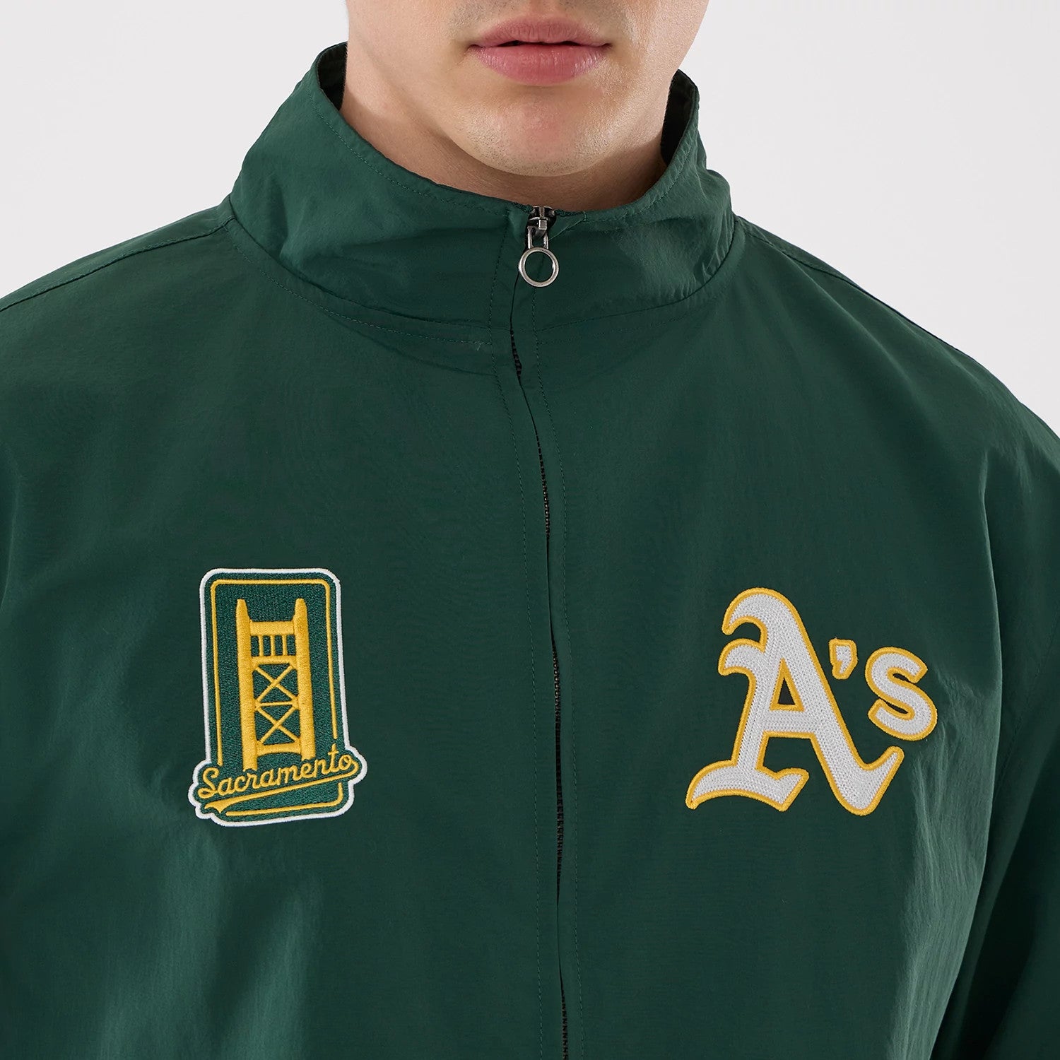 The model is wearing this MLB Athletics Sports Jacket in dark green. 5