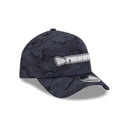 New Era Golf Black Camo 9FORTY Apex Adjustable Cap, three-quarter view showing a raised silver embroidered New Era logo on the front panel, black camo pattern throughout, and a 9FORTY size sticker on the dark visor.
