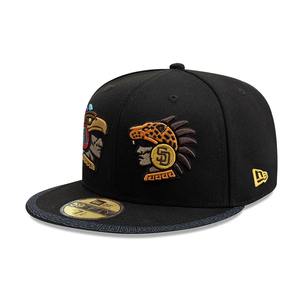 Dueling League MLB Mexico City Series 2026 Black New Era 59FIFTY Fitted Cap, three-quarter view showing intricately embroidered duelling team logos on the structured black crown, a decorative pattern on the visor, and a gold 59FIFTY size sticker.