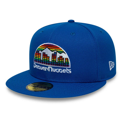 Denver Nuggets NBA Hardwood Classic Blue New Era 59FIFTY Fitted Cap, front view showing the rainbow cityscape and mountain logo embroidered on the front panel, blue visor with a gold 59FIFTY size sticker, and white New Era flag logo on the left side.