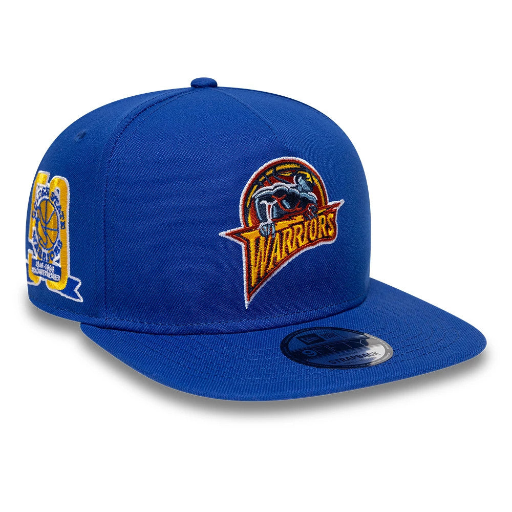 Golden State Warriors NBA Hardwood Classic Blue New Era 9FIFTY A-Frame Snapback Adjustable Cap, front view showing the embroidered Warriors logo on the front panel, a black 9FIFTY size sticker on the flat blue visor, and side championship patch.