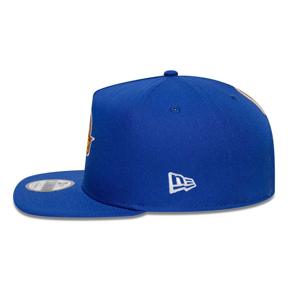 Golden State Warriors NBA Hardwood Classic Blue New Era 9FIFTY A-Frame Snapback Adjustable Cap, side view showing the white embroidered New Era flag logo on the left side, structured blue crown, and a grey 9FIFTY size sticker on the visor.